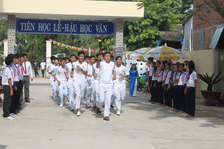 Nghi thức rước đuốc truyền thống từ lăng mộ Thủ Khoa Huân về sân trường.